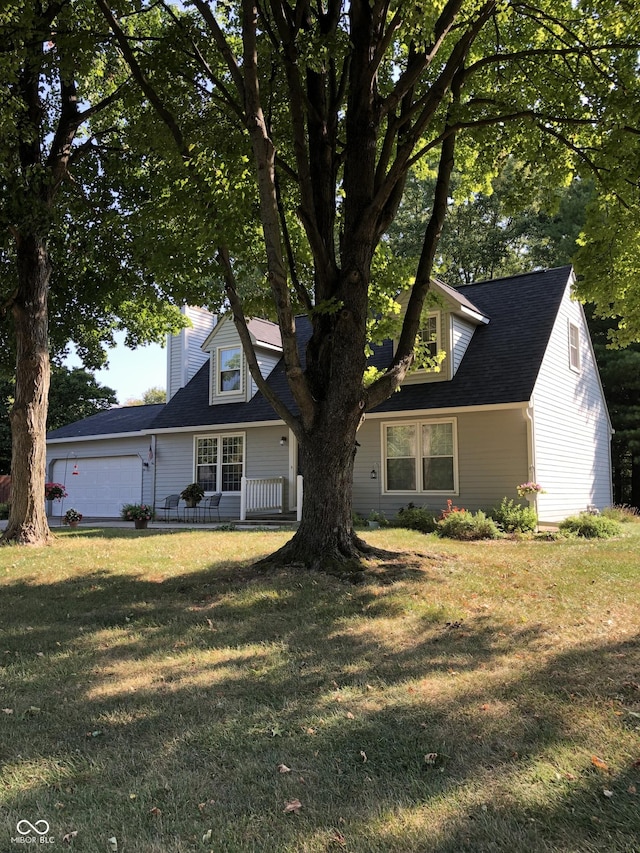 cape cod house with a garage and a front lawn