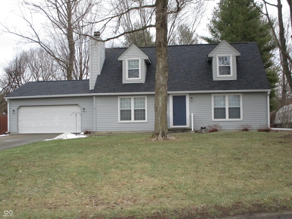 cape cod-style house featuring a garage and a front yard