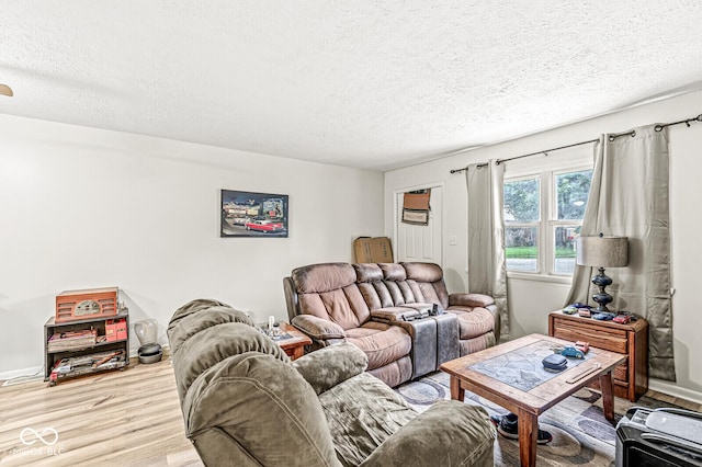 living room with hardwood / wood-style floors and a textured ceiling