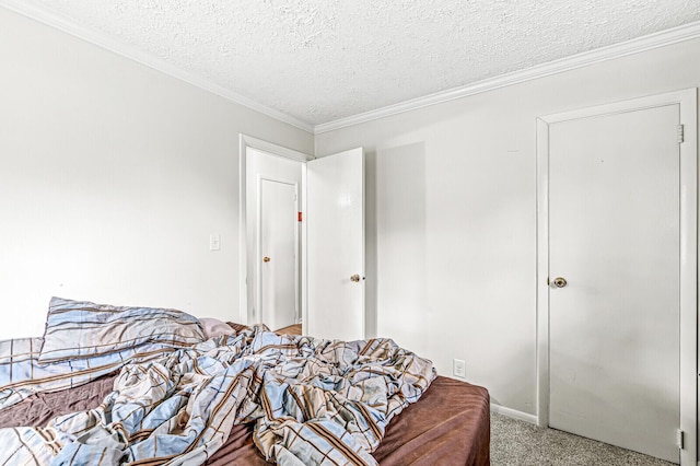 carpeted bedroom with ornamental molding and a textured ceiling