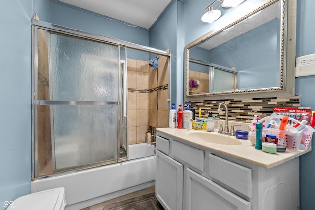 full bathroom with vanity, backsplash, enclosed tub / shower combo, and toilet