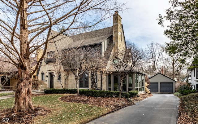 view of front facade featuring a garage and an outdoor structure