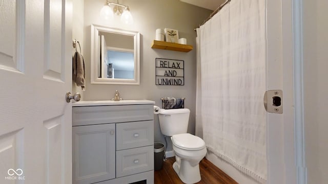 bathroom featuring hardwood / wood-style flooring, vanity, and toilet