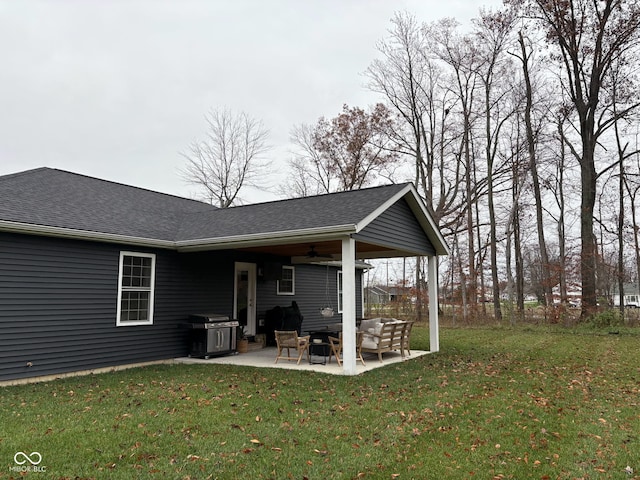 back of property with a yard and a patio