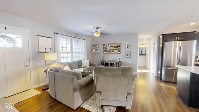 living room featuring ceiling fan and light hardwood / wood-style floors