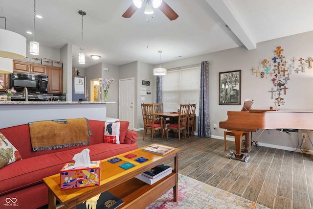 living room with ceiling fan and beam ceiling