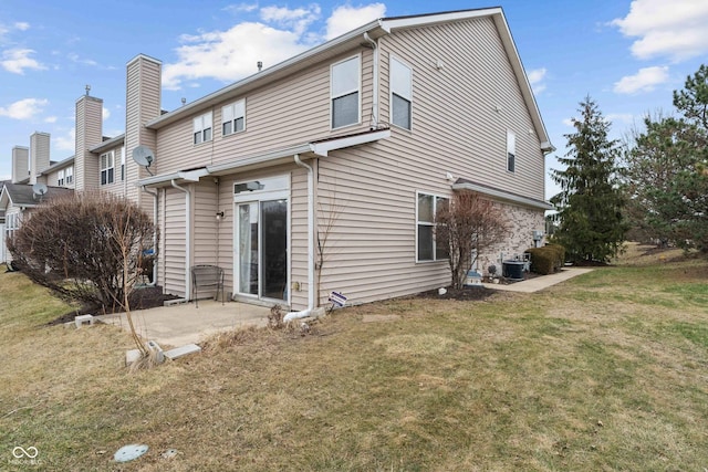 rear view of property with a patio, central AC unit, and a lawn