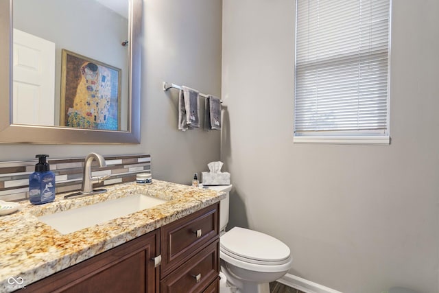 bathroom featuring vanity and toilet