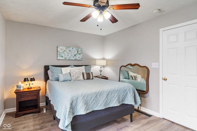 bedroom with wood-type flooring and ceiling fan