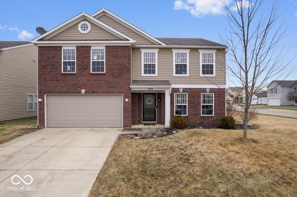 view of front of house with a garage and a front lawn