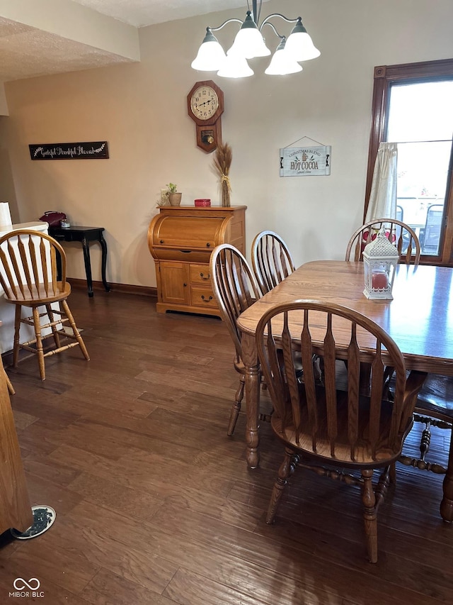 dining area with an inviting chandelier and dark hardwood / wood-style floors