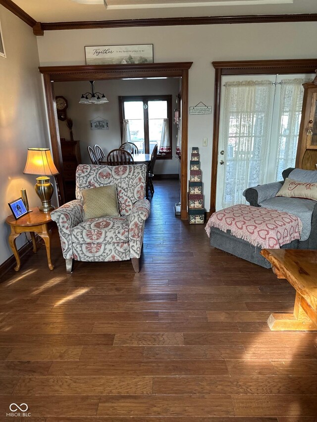 living room featuring crown molding and dark hardwood / wood-style floors