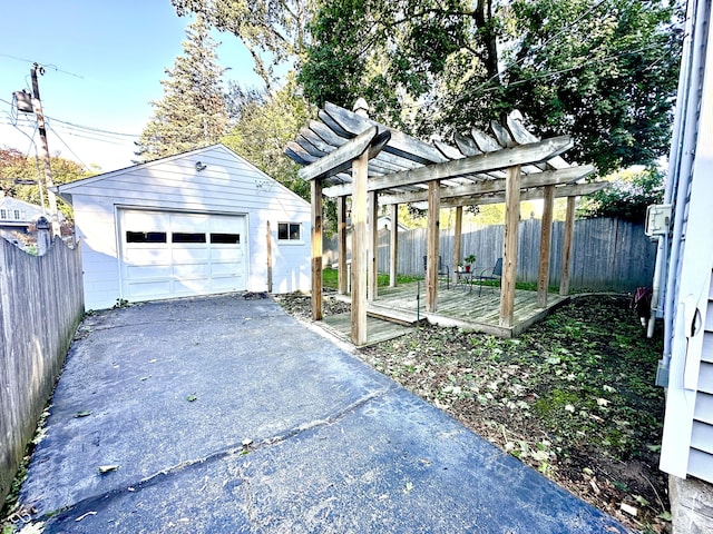 exterior space with a pergola, a garage, an outbuilding, and a deck