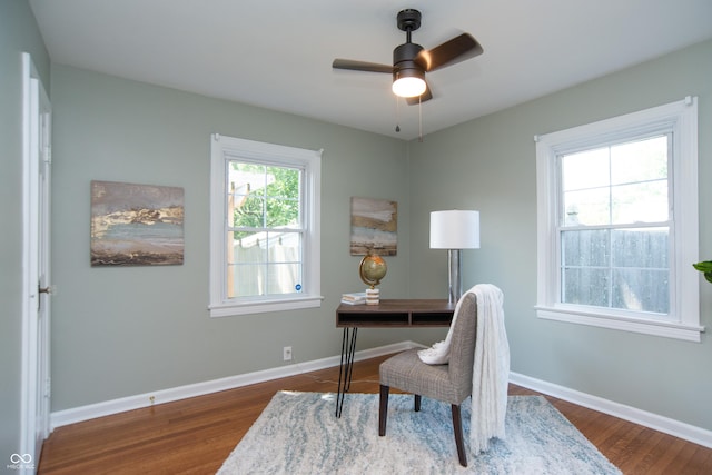 home office featuring dark wood-type flooring and ceiling fan