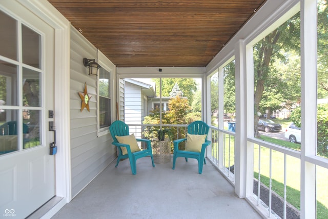 sunroom featuring plenty of natural light and wooden ceiling