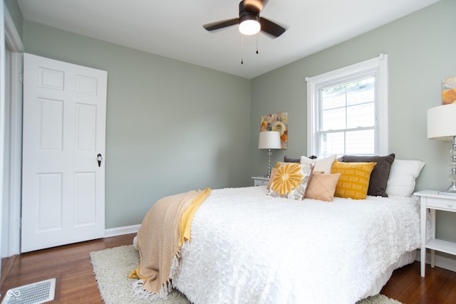 bedroom with ceiling fan and dark hardwood / wood-style flooring