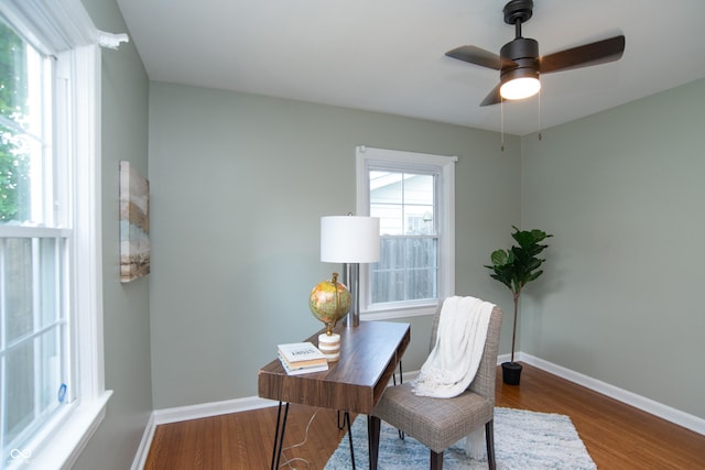 home office featuring hardwood / wood-style floors and ceiling fan