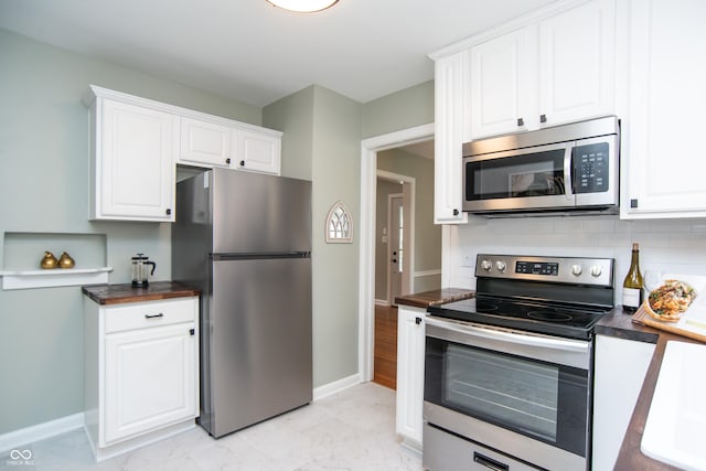 kitchen featuring tasteful backsplash, stainless steel appliances, and white cabinets