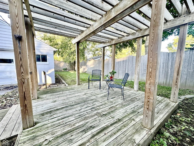 wooden terrace with an outdoor structure and a pergola