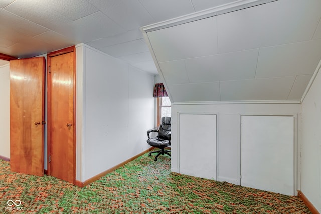 interior space featuring lofted ceiling and carpet