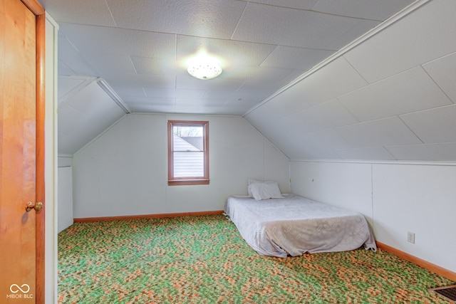 carpeted bedroom featuring lofted ceiling