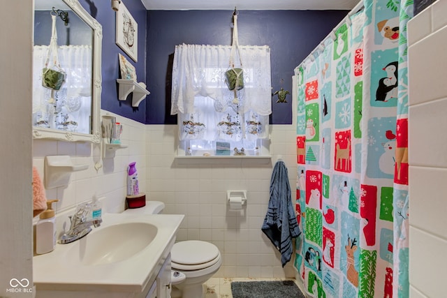 bathroom with tile patterned floors, toilet, tile walls, vanity, and a shower with shower curtain