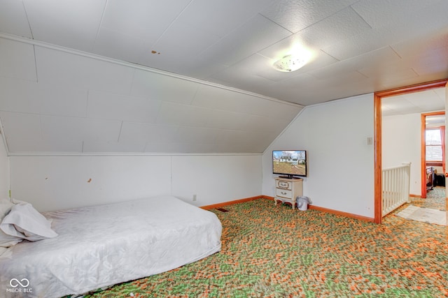 carpeted bedroom with vaulted ceiling