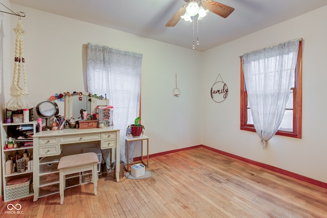 home office featuring light hardwood / wood-style flooring and ceiling fan