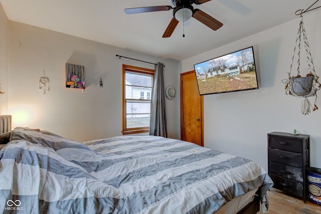 bedroom with hardwood / wood-style flooring and ceiling fan