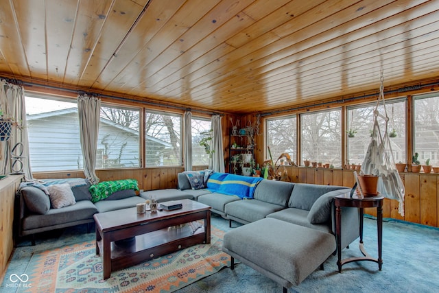 living room featuring wood ceiling, wooden walls, and carpet