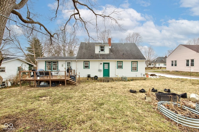 back of property with a wooden deck, central AC unit, and a lawn