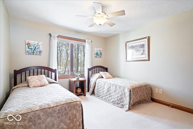 carpeted bedroom featuring baseboards, a textured ceiling, and ceiling fan