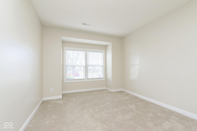 unfurnished room with light colored carpet