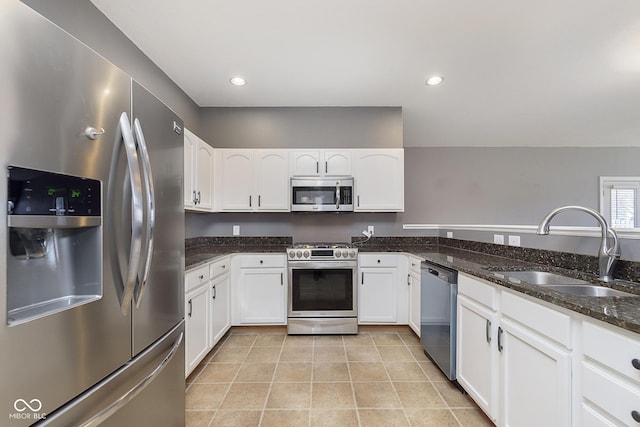 kitchen with stainless steel appliances, sink, and white cabinets