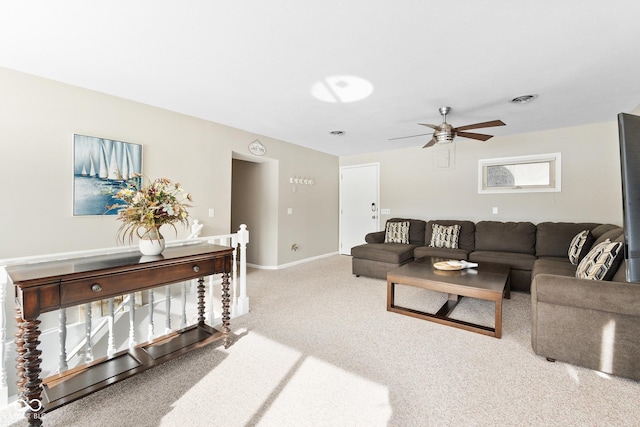 carpeted living room with ceiling fan