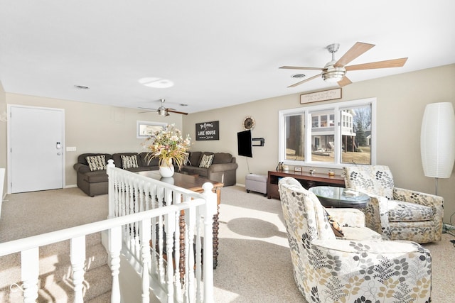 living room with ceiling fan and light colored carpet