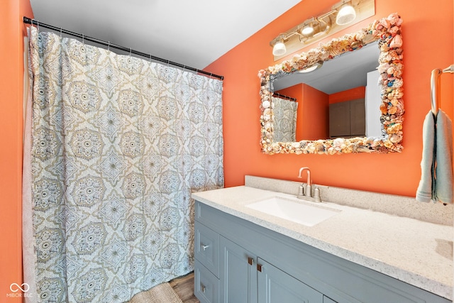 bathroom with vanity and wood-type flooring