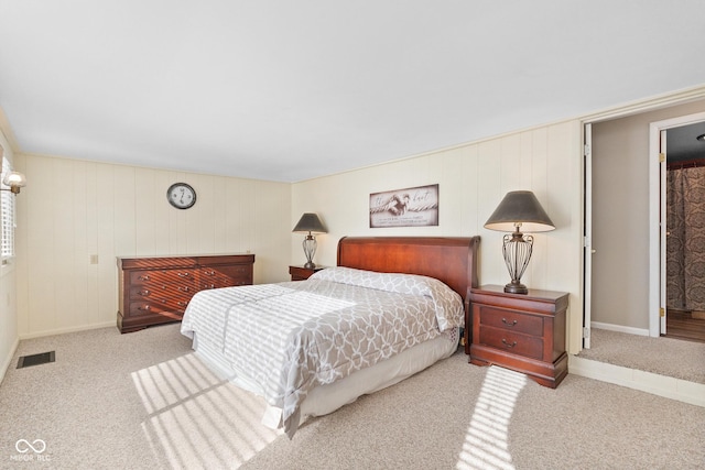 bedroom featuring light carpet