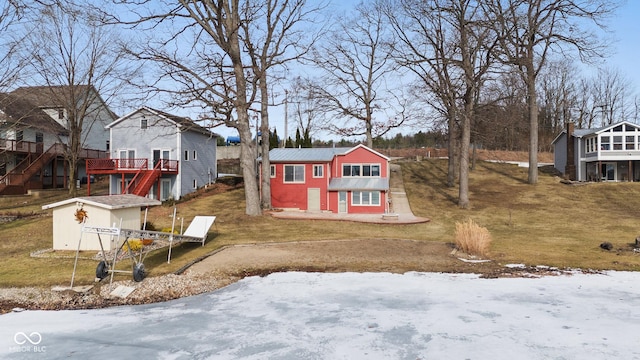 yard layered in snow with a storage shed and a wooden deck