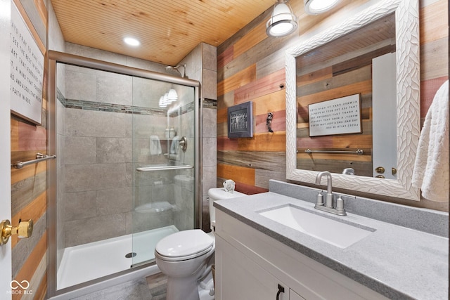 bathroom featuring vanity, wooden walls, wooden ceiling, and toilet