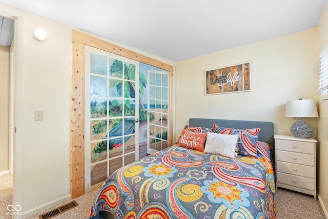 bedroom featuring multiple windows and carpet