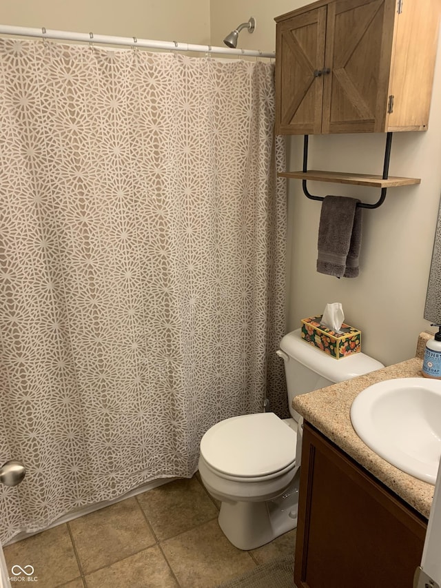 bathroom with tile patterned floors, vanity, and toilet