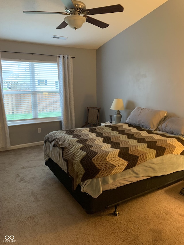 carpeted bedroom with lofted ceiling and ceiling fan