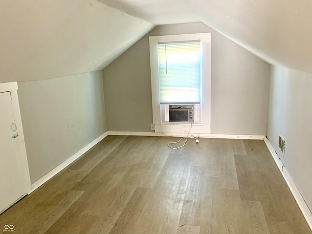 bonus room featuring wood-type flooring and vaulted ceiling