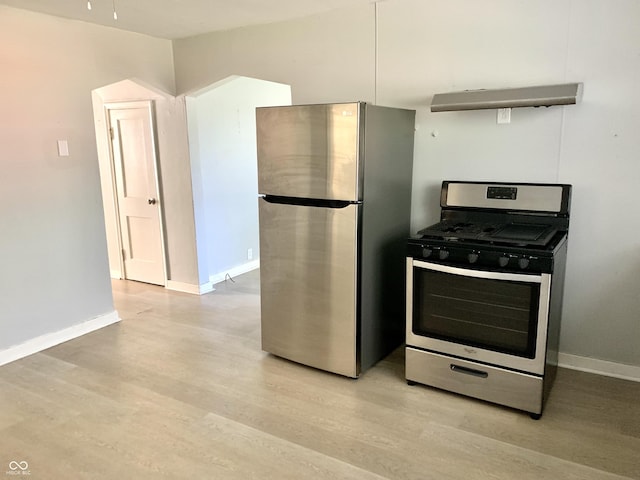 kitchen featuring appliances with stainless steel finishes and light hardwood / wood-style flooring