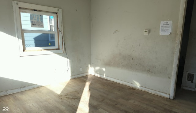 empty room with hardwood / wood-style floors