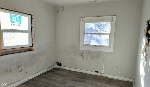 unfurnished room featuring dark hardwood / wood-style flooring