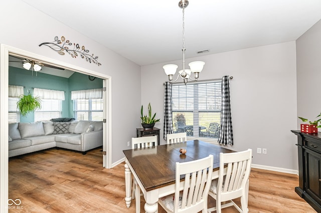 dining space featuring a chandelier and light hardwood / wood-style flooring