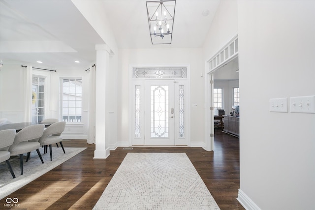 foyer entrance featuring a chandelier and dark hardwood / wood-style flooring