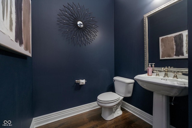 bathroom featuring wood-type flooring and toilet